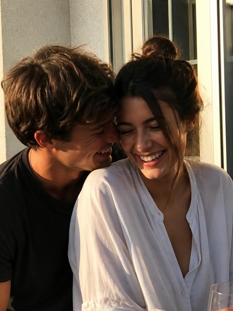 The original reference photograph of a couple laughing in warm daylight